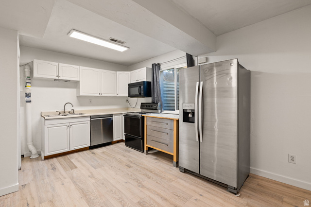 594 850 West Provo, UT 84601 - Photo 21 of 33 Kitchen area featuring light wood-finish flooring, white cabinetry, and a light-toned countertop
