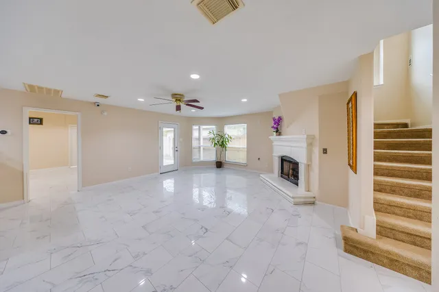 a large kitchen with stainless steel appliances granite countertop a stove and a refrigerator