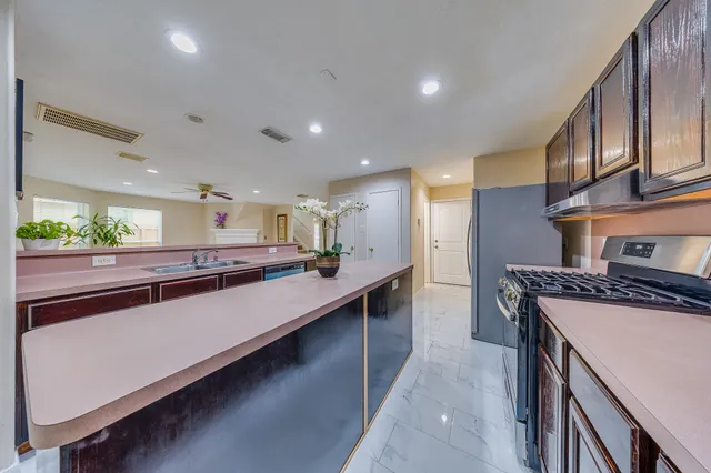 an empty room with windows and ceiling fan