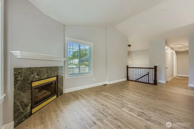 a view of a livingroom with a fireplace and window