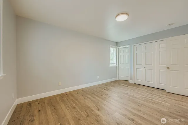 a view of an empty room and wooden floor