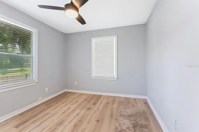 an empty room with a empty space and windows