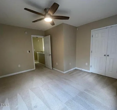 an empty room with fan and a ceiling fan