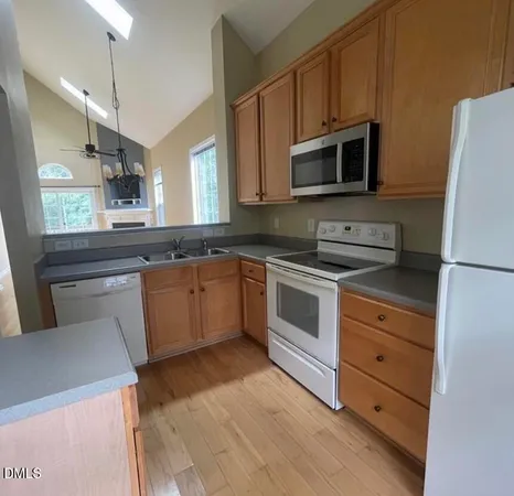 a kitchen with a sink stove and microwave
