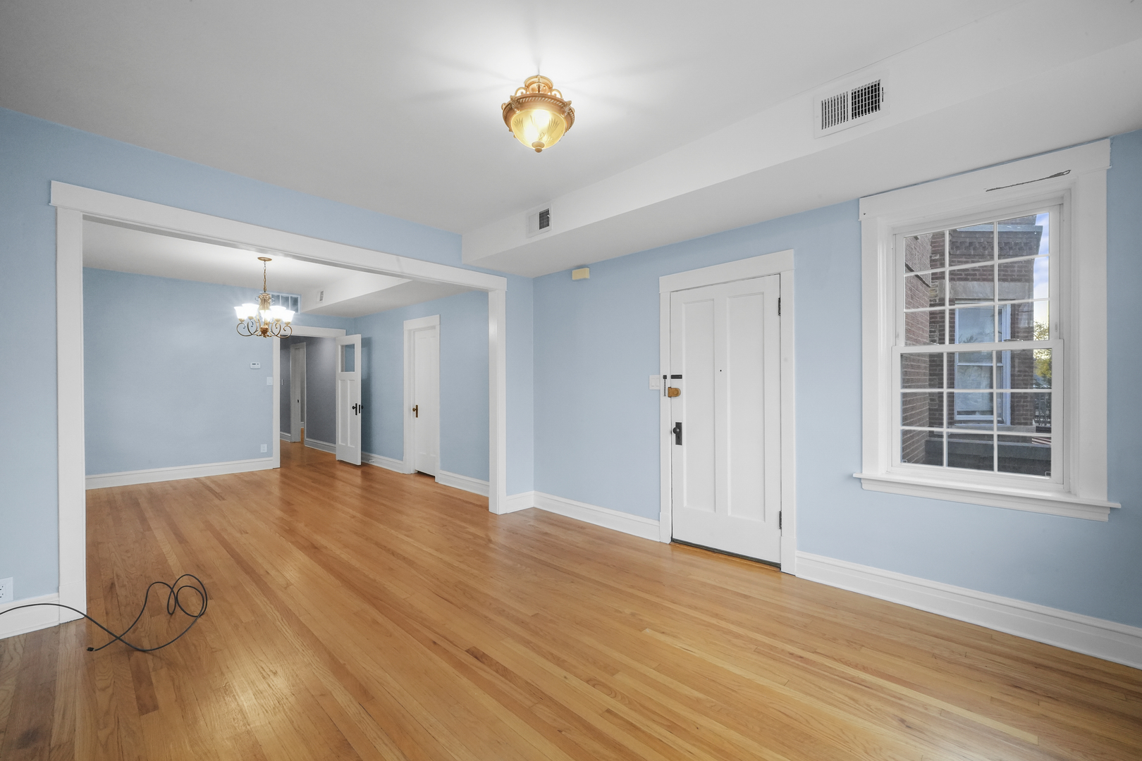 4239 West Melrose Street, Unit 2 Chicago, IL 60641 - Photo 11 of 27 a view of empty room with wooden floor and fan