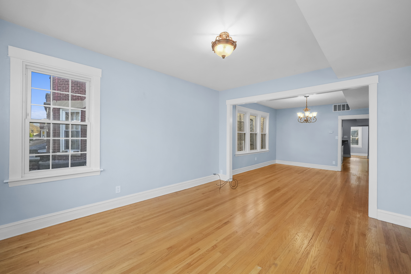 4239 West Melrose Street, Unit 2 Chicago, IL 60641 - Photo 14 of 27 a view of empty room with wooden floor and fan