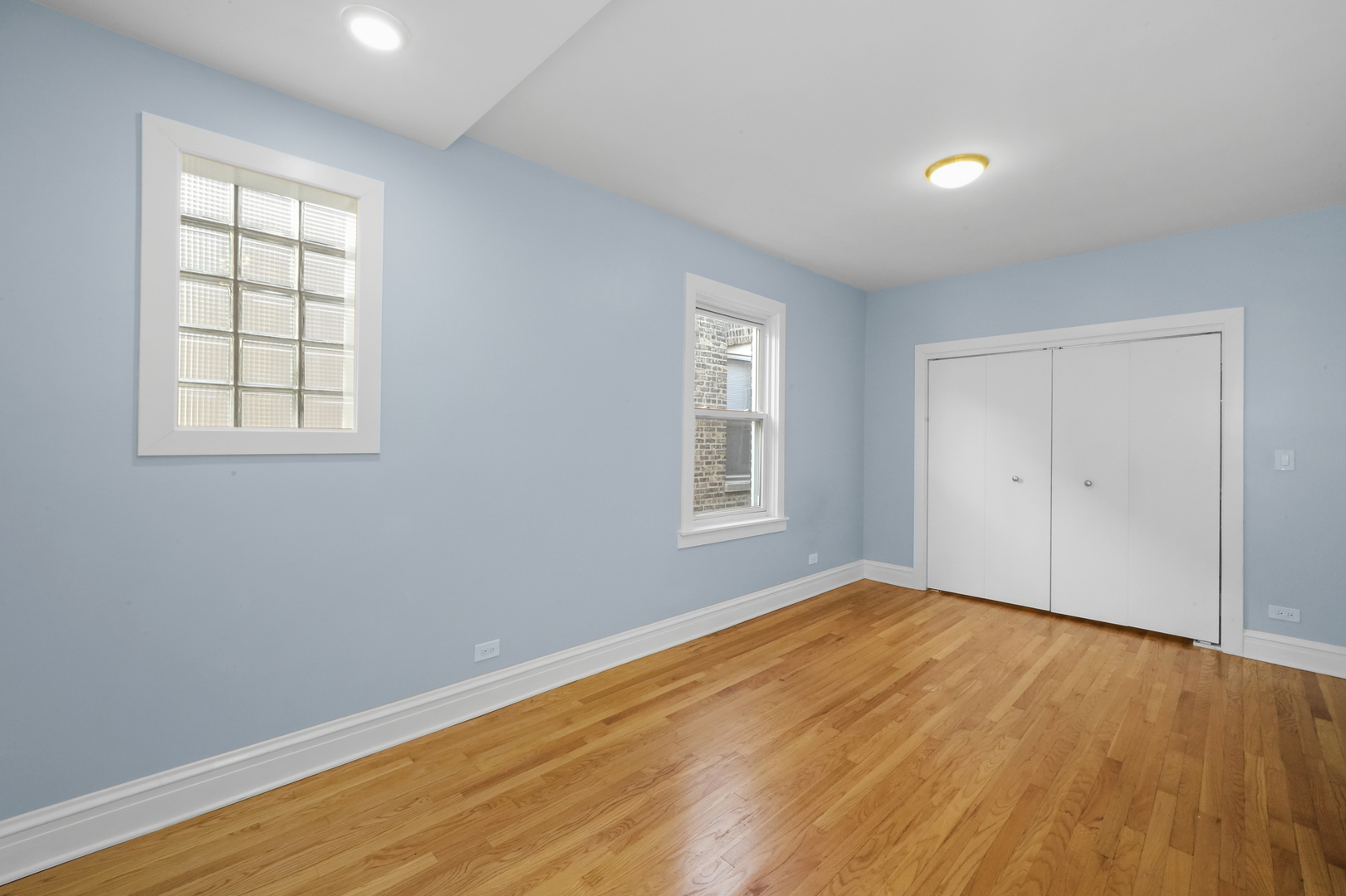 4239 West Melrose Street, Unit 2 Chicago, IL 60641 - Photo 18 of 27 an empty room with wooden floor and windows
