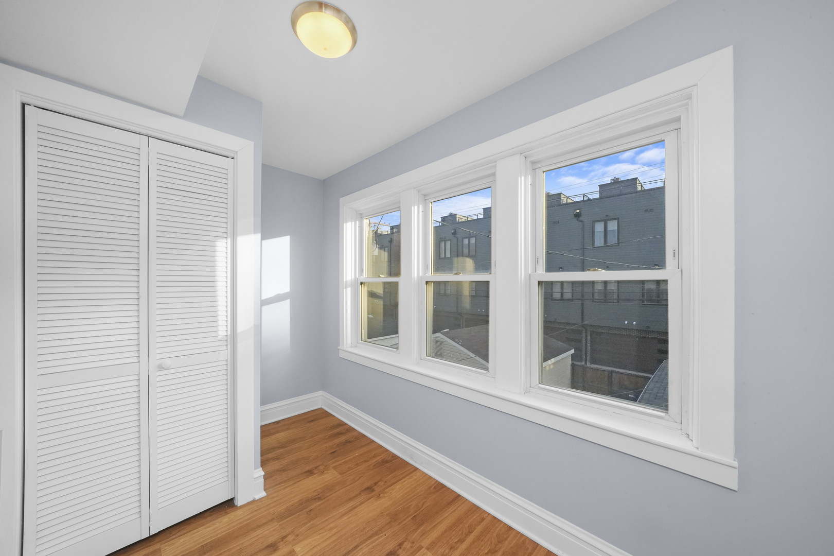 4239 West Melrose Street, Unit 2 Chicago, IL 60641 - Photo 24 of 27 a view of an empty room with wooden floor and a window
