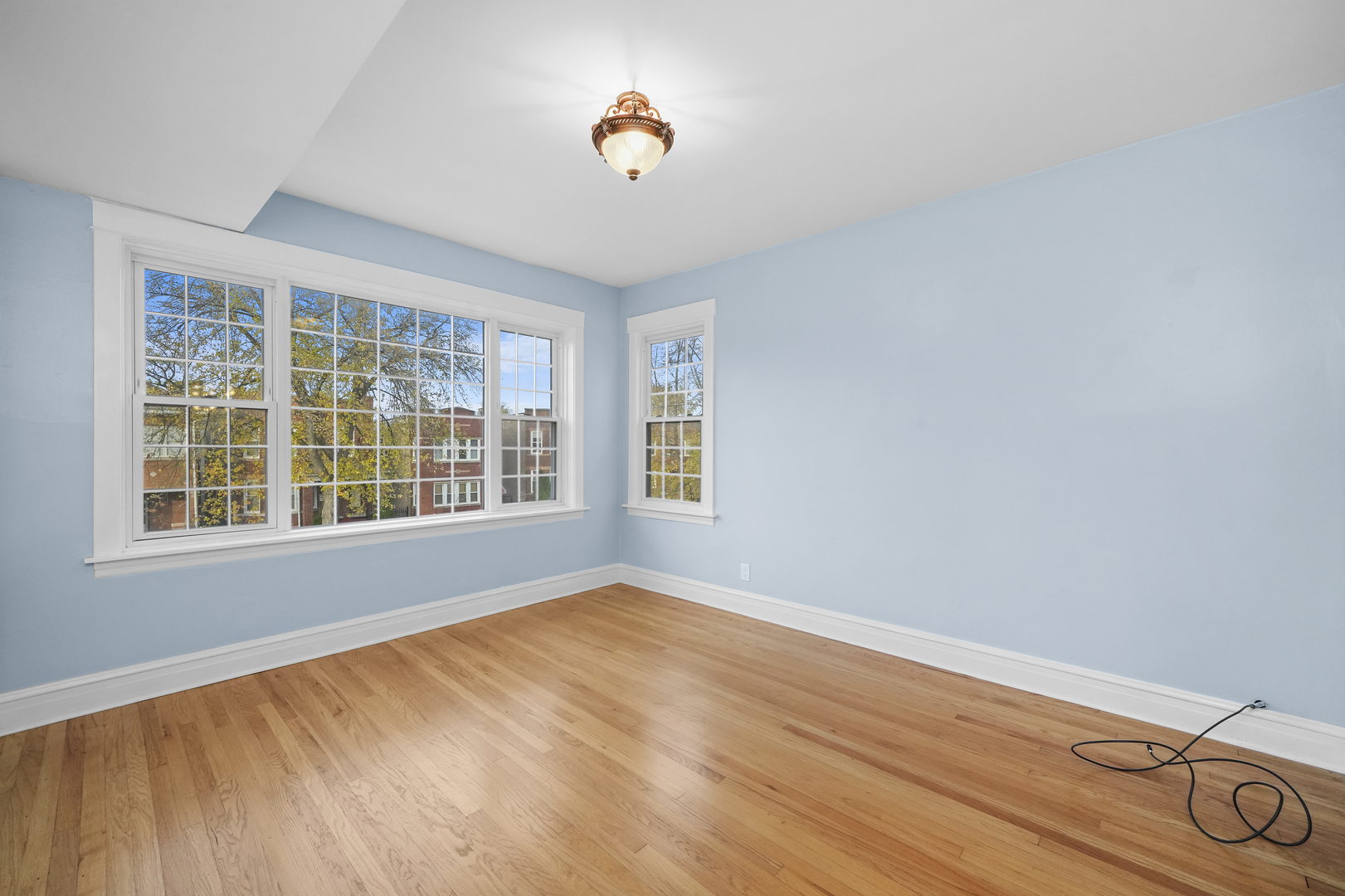 4239 West Melrose Street, Unit 2 Chicago, IL 60641 - Photo 8 of 27 a view of an empty room with wooden floor and a window