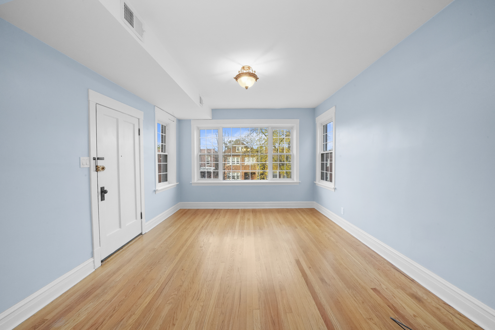 4239 West Melrose Street, Unit 2 Chicago, IL 60641 - Photo 9 of 27 wooden floor in an empty room with a window