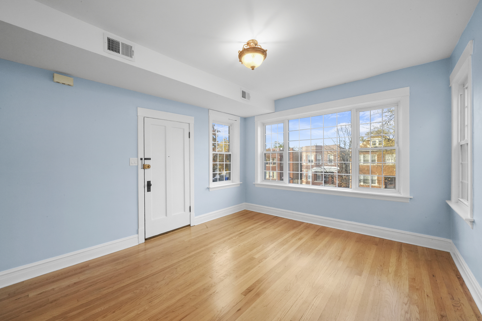 4239 West Melrose Street, Unit 2 Chicago, IL 60641 - Photo 10 of 27 a view of an empty room with a window and wooden floor