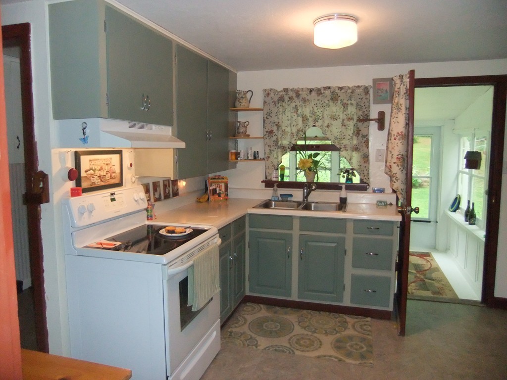 8 Clark Road Holland, MA 01521 - Photo 10 of 30 a kitchen with stainless steel appliances granite countertop a stove a sink and a microwave