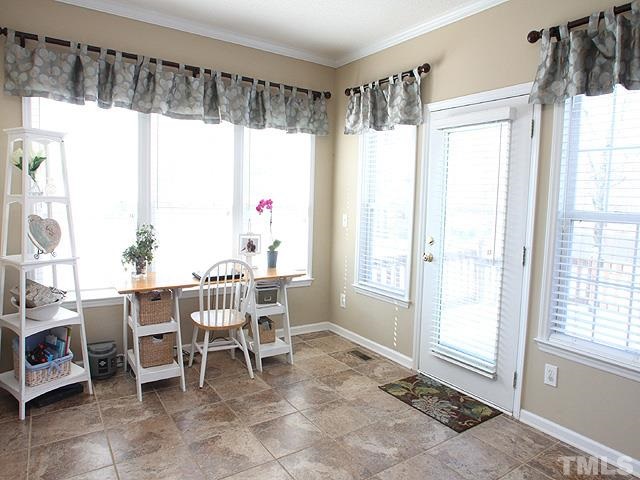 4908 Topstone Road Raleigh, NC 27603 - Photo 5 of 14 a dining room with furniture and large windows