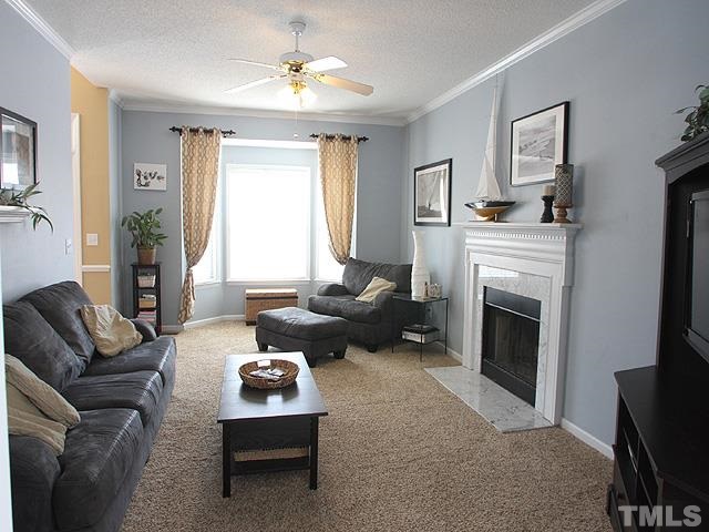 4908 Topstone Road Raleigh, NC 27603 - Photo 6 of 14 a living room with furniture and a fireplace