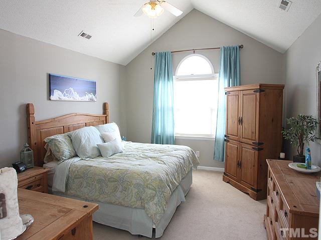4908 Topstone Road Raleigh, NC 27603 - Photo 7 of 14 a bed room with a bed and a television