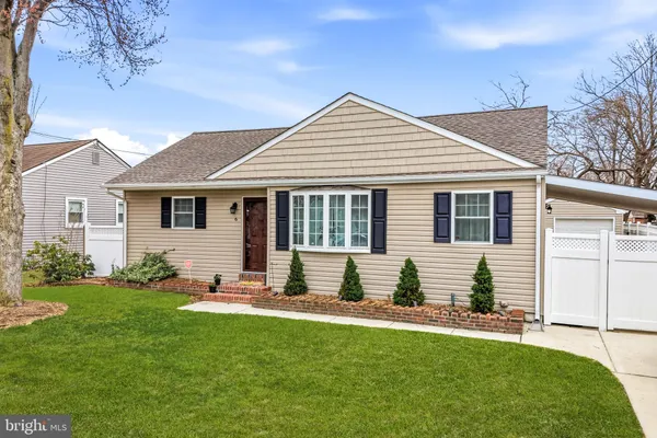 a front view of a house with yard and green space