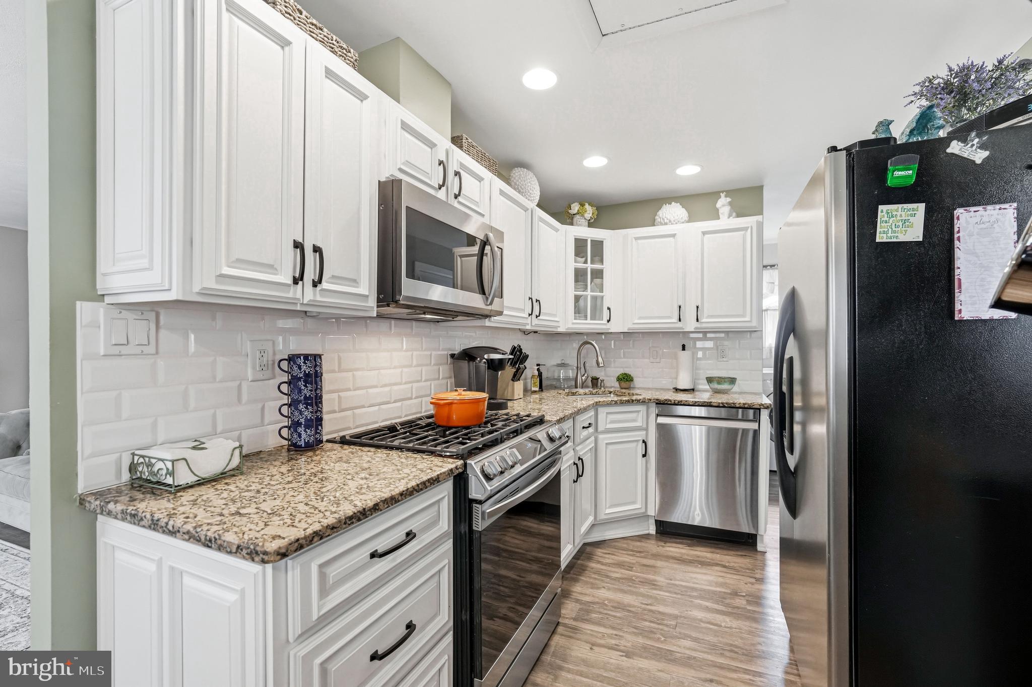 6 Woodbine Avenue Maple Shade, NJ 08052 - Photo 11 of 35 a kitchen with stainless steel appliances granite countertop a stove sink microwave and cabinets