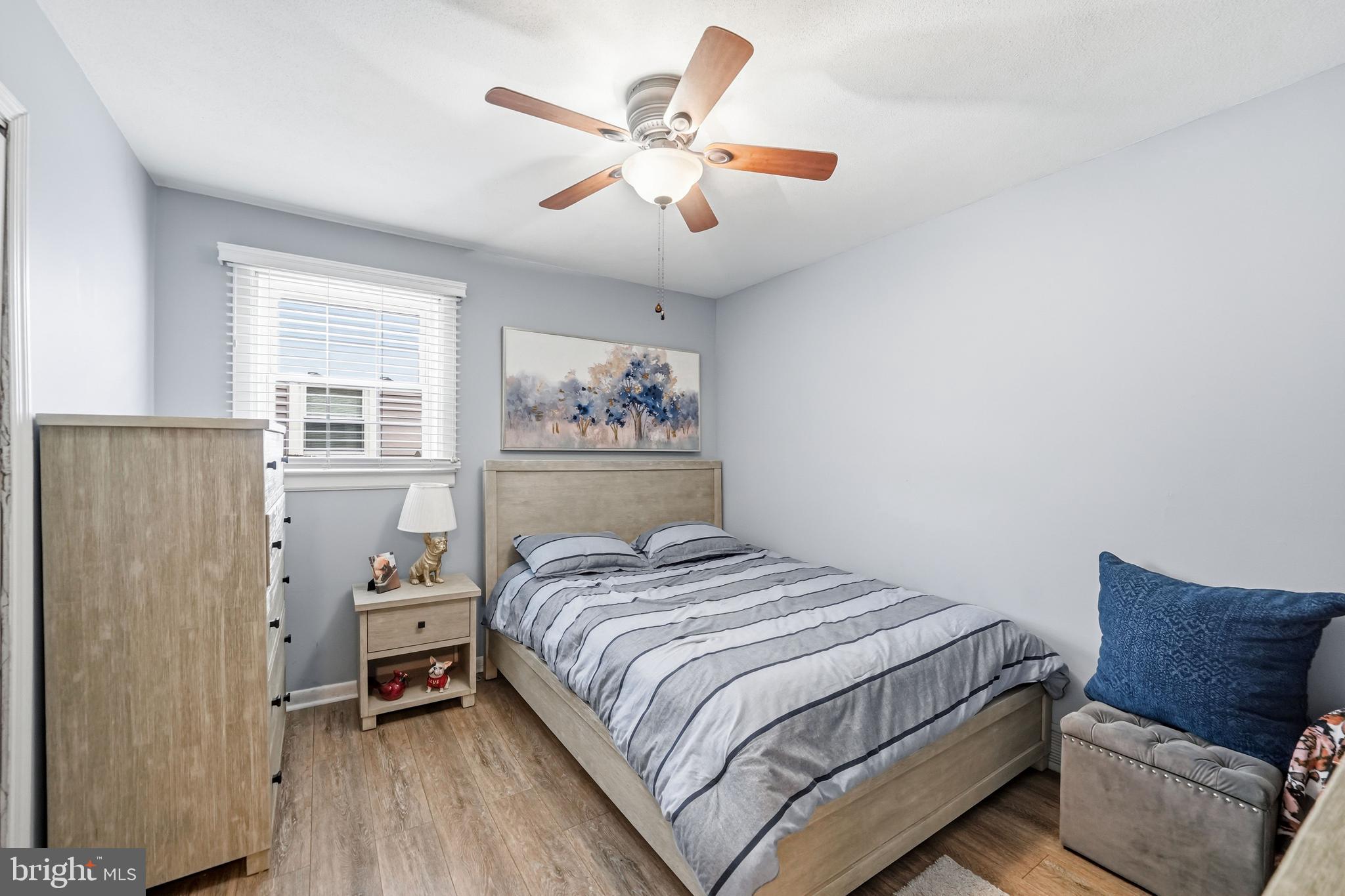 6 Woodbine Avenue Maple Shade, NJ 08052 - Photo 14 of 35 a bedroom with a bed and a chandelier