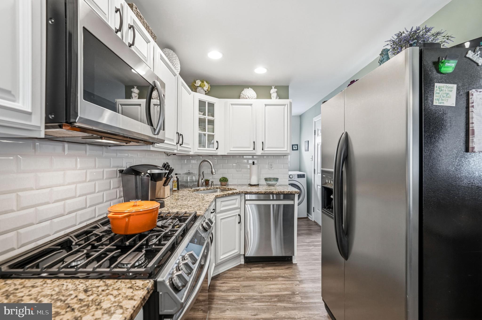 6 Woodbine Avenue Maple Shade, NJ 08052 - Photo 10 of 35 a kitchen with stainless steel appliances granite countertop a stove a refrigerator and a sink