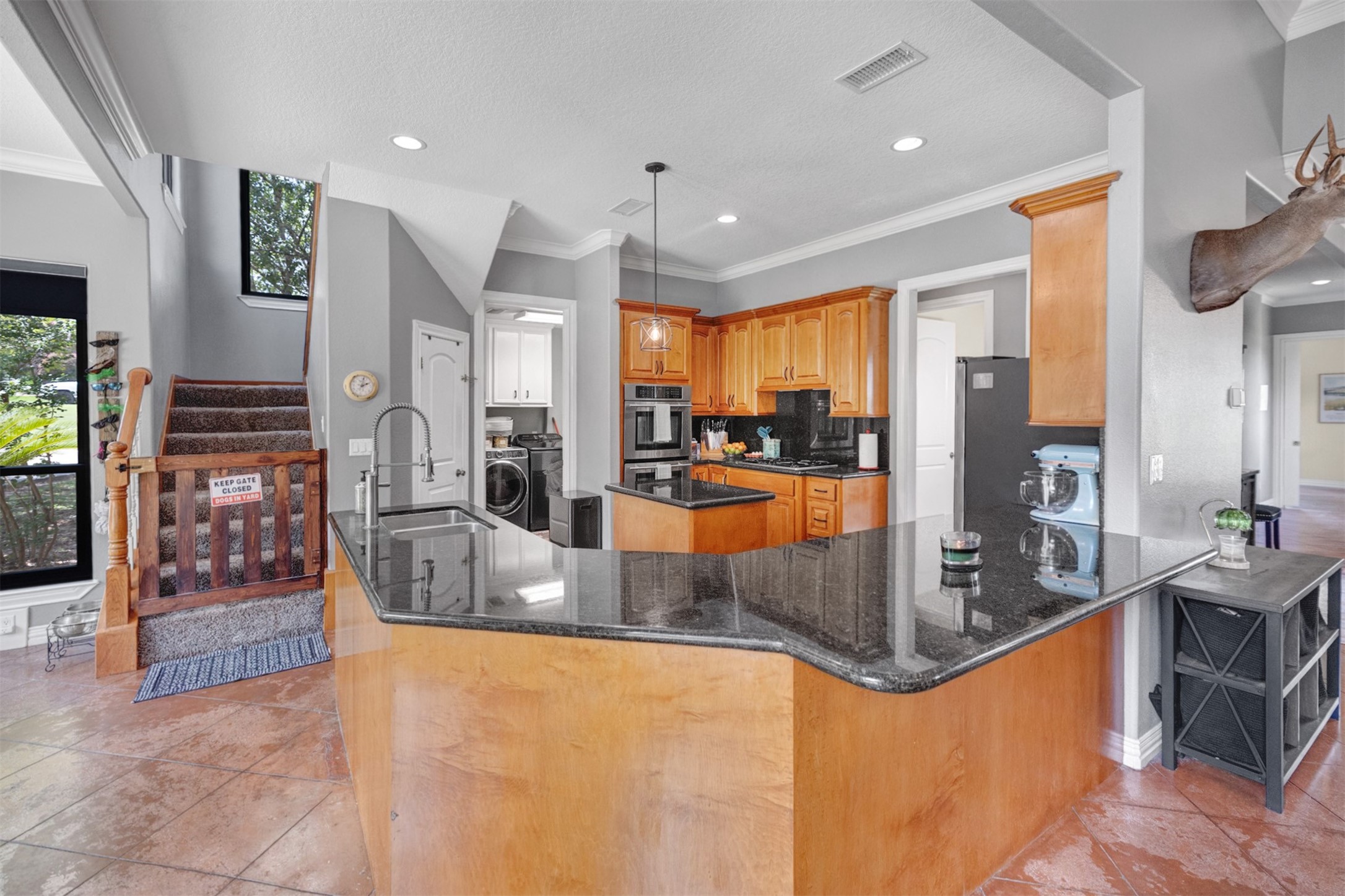 20019 Peel Road Montgomery, TX 77356 - Photo 17 of 46 The granite countertops extend into a bar area, cover the island, and more. They offer plenty of counter space for cooking and entertaining.