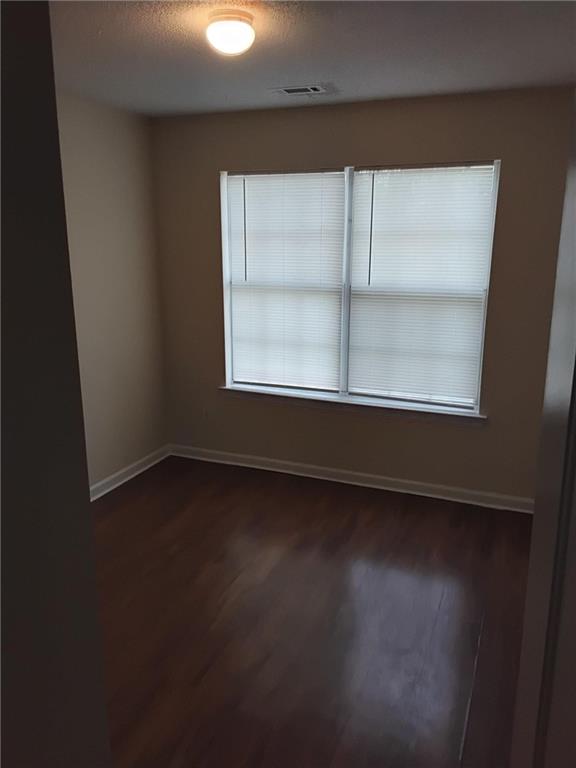 2390 Coach Way Jonesboro, GA 30236 - Photo 7 of 15 an empty room with wooden floor and windows