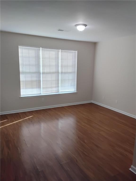 2390 Coach Way Jonesboro, GA 30236 - Photo 8 of 15 an empty room with wooden floor and windows