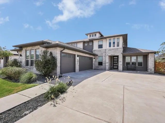 a front view of a house with a yard and garage
