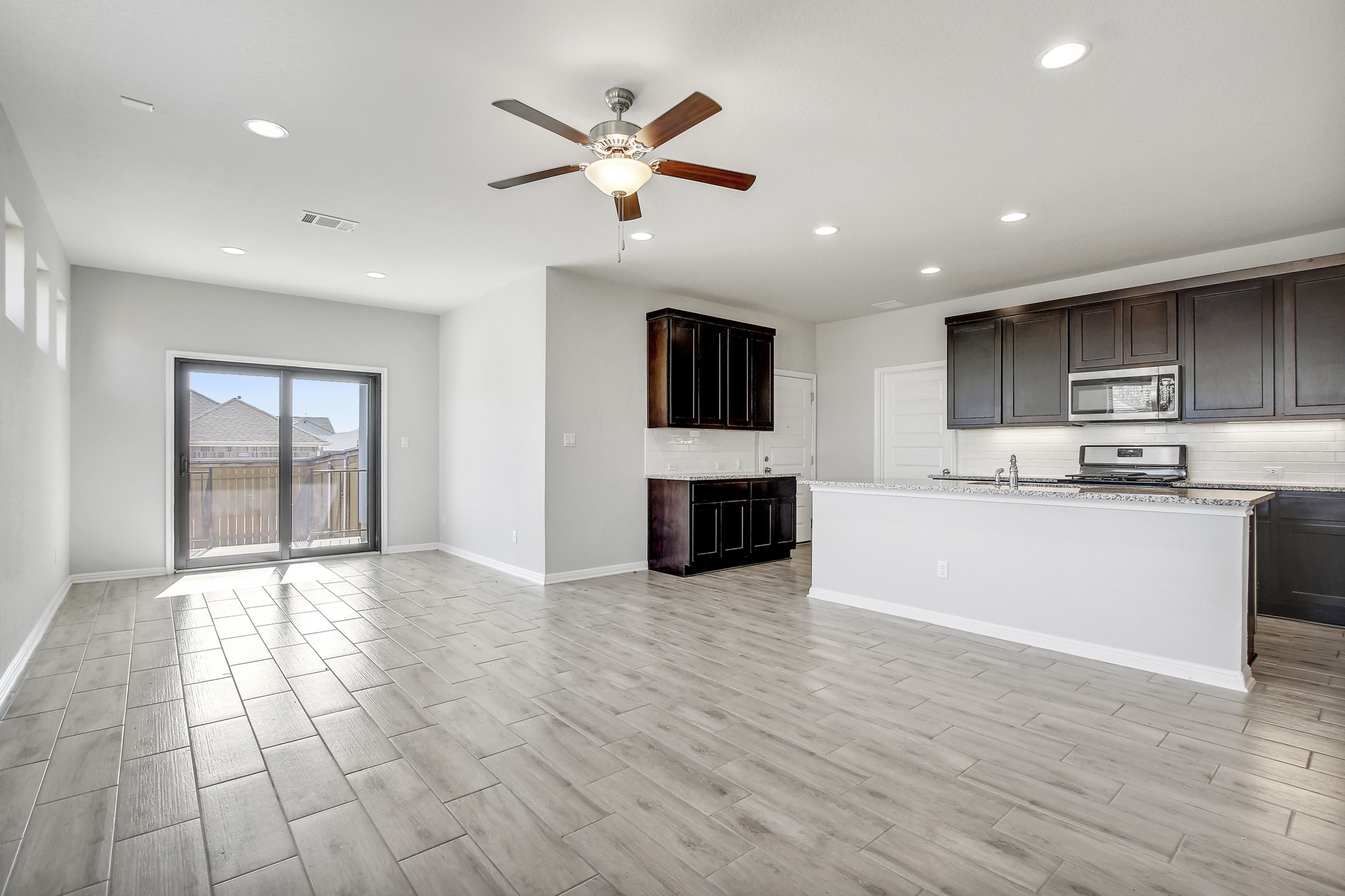 1220 Oak Chase Way Leander, TX 78641 - Photo 13 of 14 a view of kitchen with microwave a stove and wooden floor