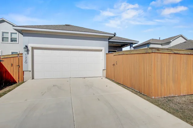 a backyard of a house with wooden fence