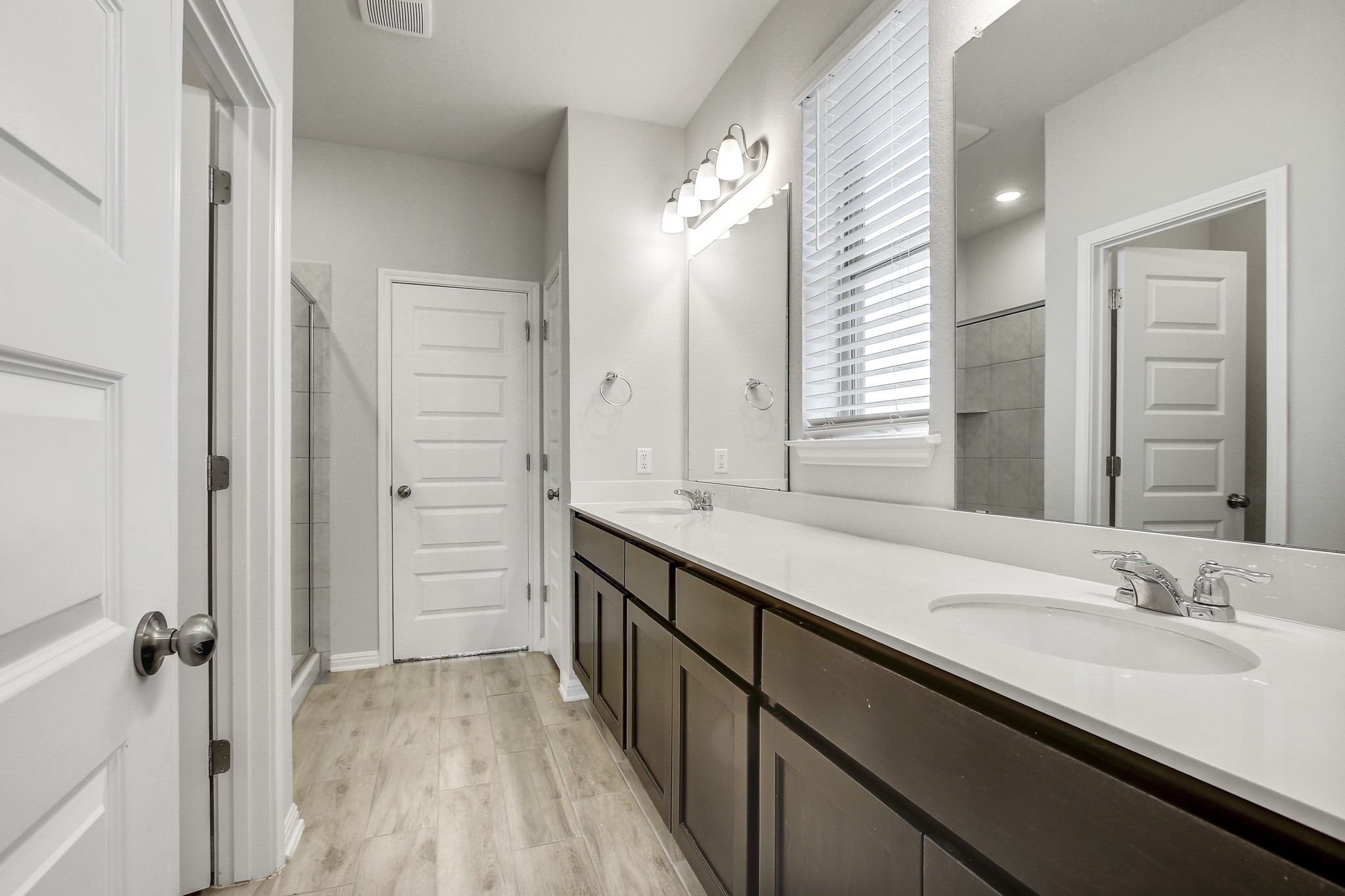 1220 Oak Chase Way Leander, TX 78641 - Photo 6 of 14 a bathroom with a double vanity sink a mirror and a shower
