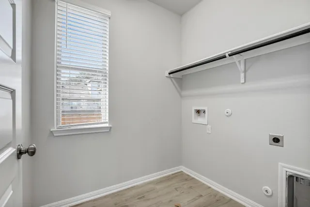 a view of a storage & utility room with a window