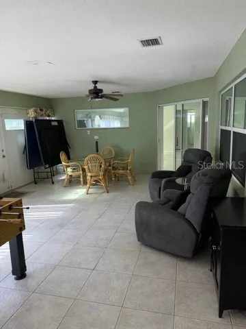 a living room with furniture gym equipment and a window