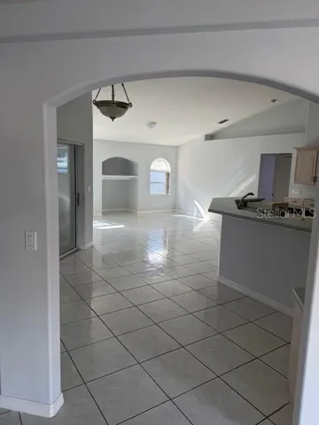 a kitchen with granite countertop a sink a stove and cabinets