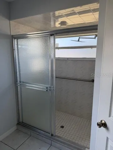 a bathroom with a glass shower door