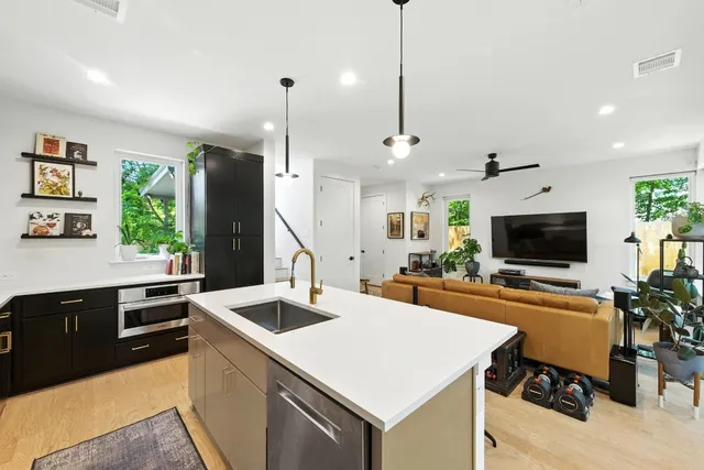 a kitchen with a sink a counter top space and appliances