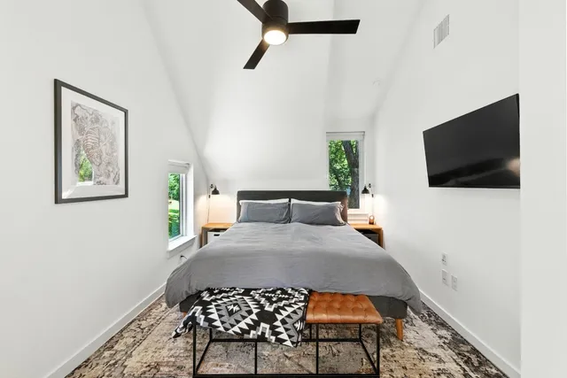 a bedroom with a bed and a flat screen tv