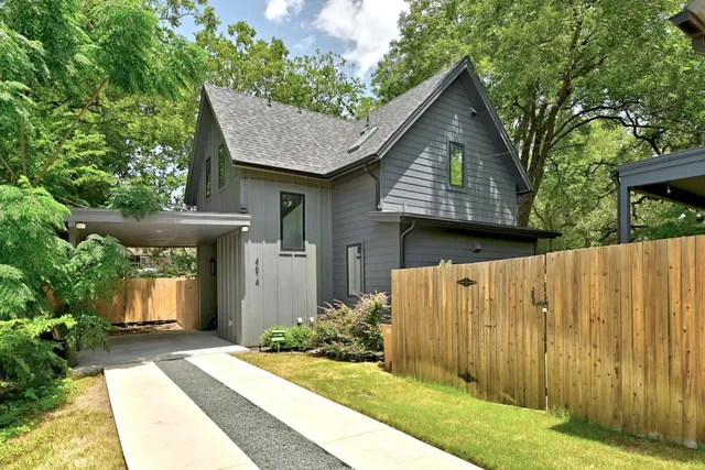 a front view of a house with a garden and plants