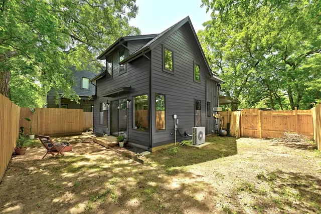 a backyard of a house with a tree