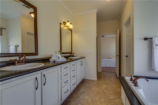 120 Piney Road Dickson, TN 37055 - Photo 12 of 20 Master bath double vanities, copper fixtures, laminate flooring.