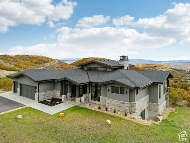 2280 East Outlaw Road, Unit 56 Kamas, UT 84036 - Photo 1 of 59 View of front of house with stone siding, a chimney, driveway, and a garage
