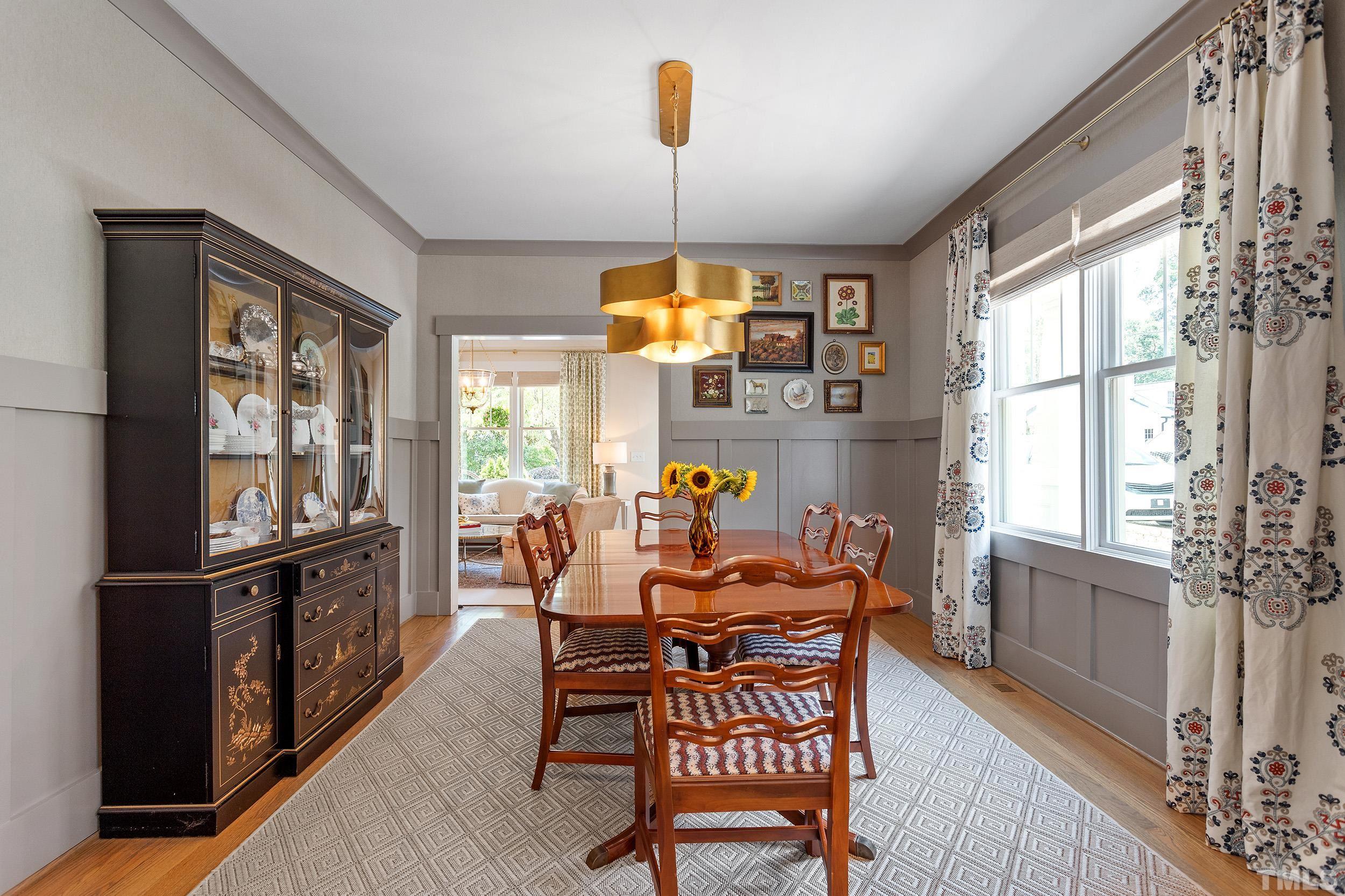2511 Beechridge Road Raleigh, NC 27608 - Photo 13 of 45 a dining room with furniture window wooden floor and a chandelier