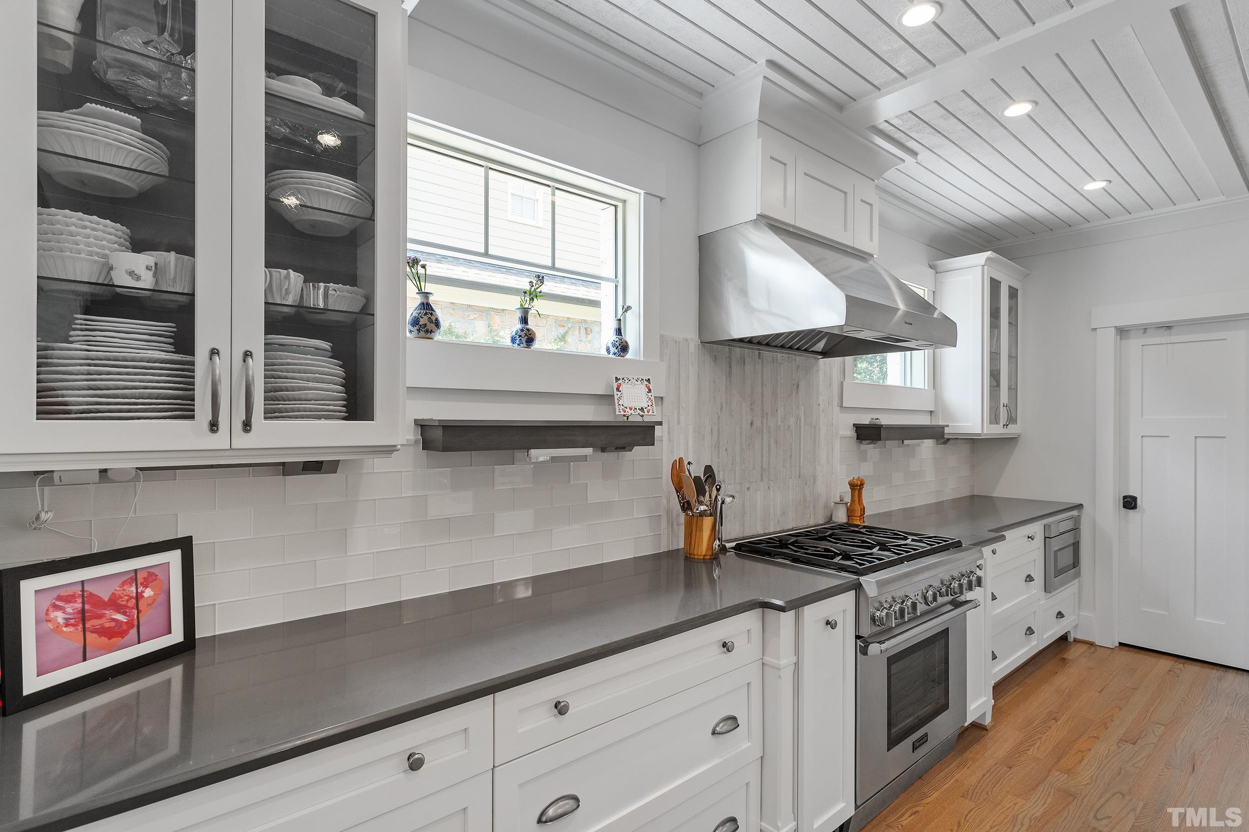 2511 Beechridge Road Raleigh, NC 27608 - Photo 17 of 45 a kitchen with stainless steel appliances granite countertop a sink a stove and a wooden floors