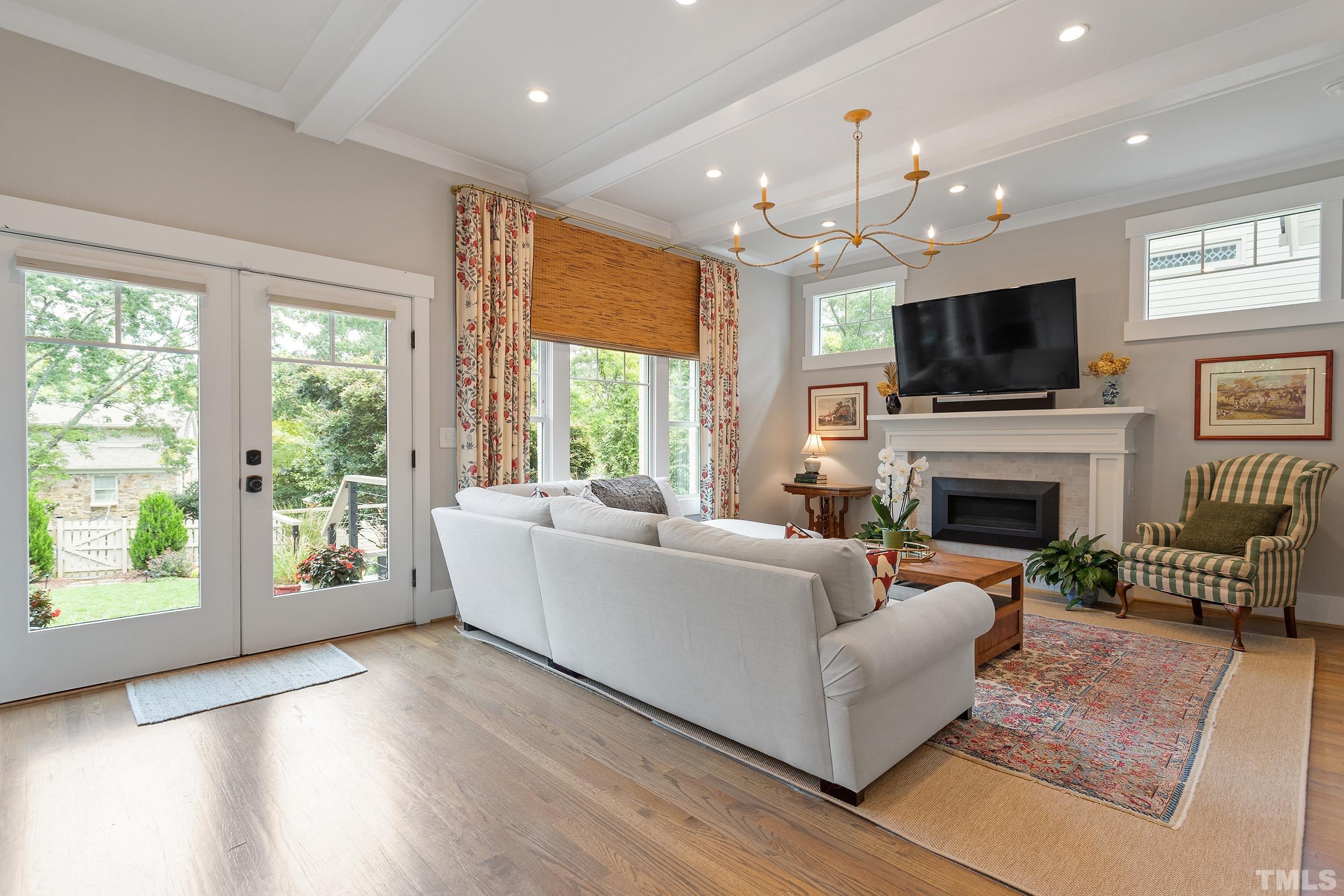 2511 Beechridge Road Raleigh, NC 27608 - Photo 21 of 45 a living room with furniture a flat screen tv and a fireplace