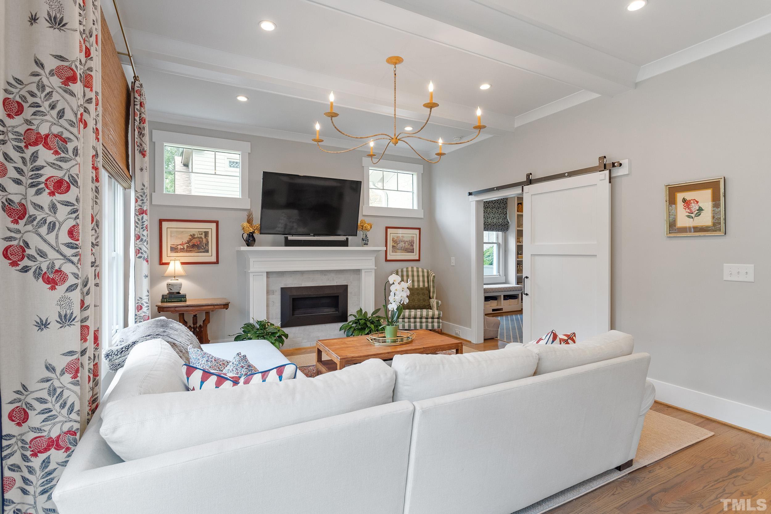 2511 Beechridge Road Raleigh, NC 27608 - Photo 22 of 45 a living room with furniture a flat screen tv and a fireplace
