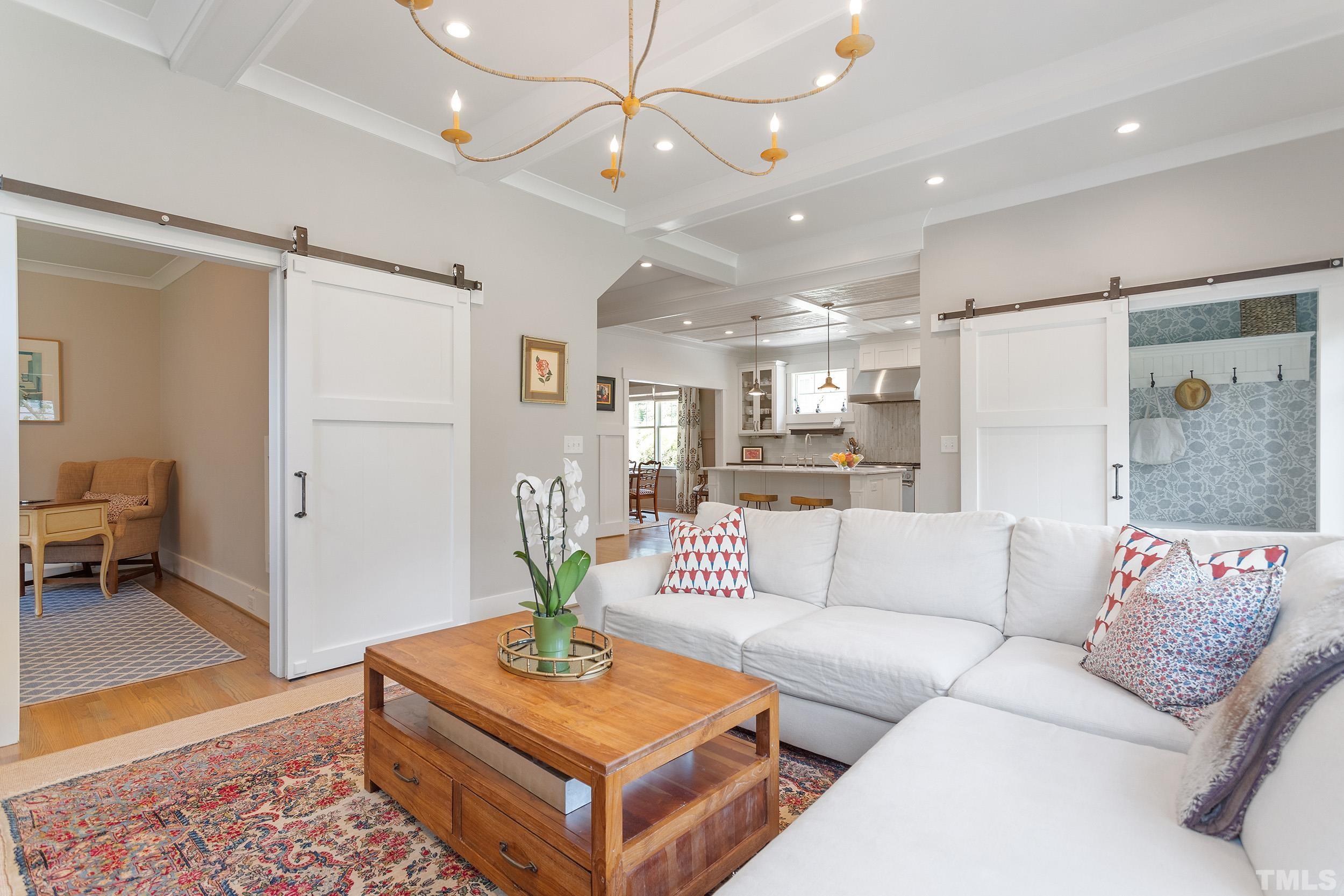 2511 Beechridge Road Raleigh, NC 27608 - Photo 24 of 45 a living room with furniture and a chandelier