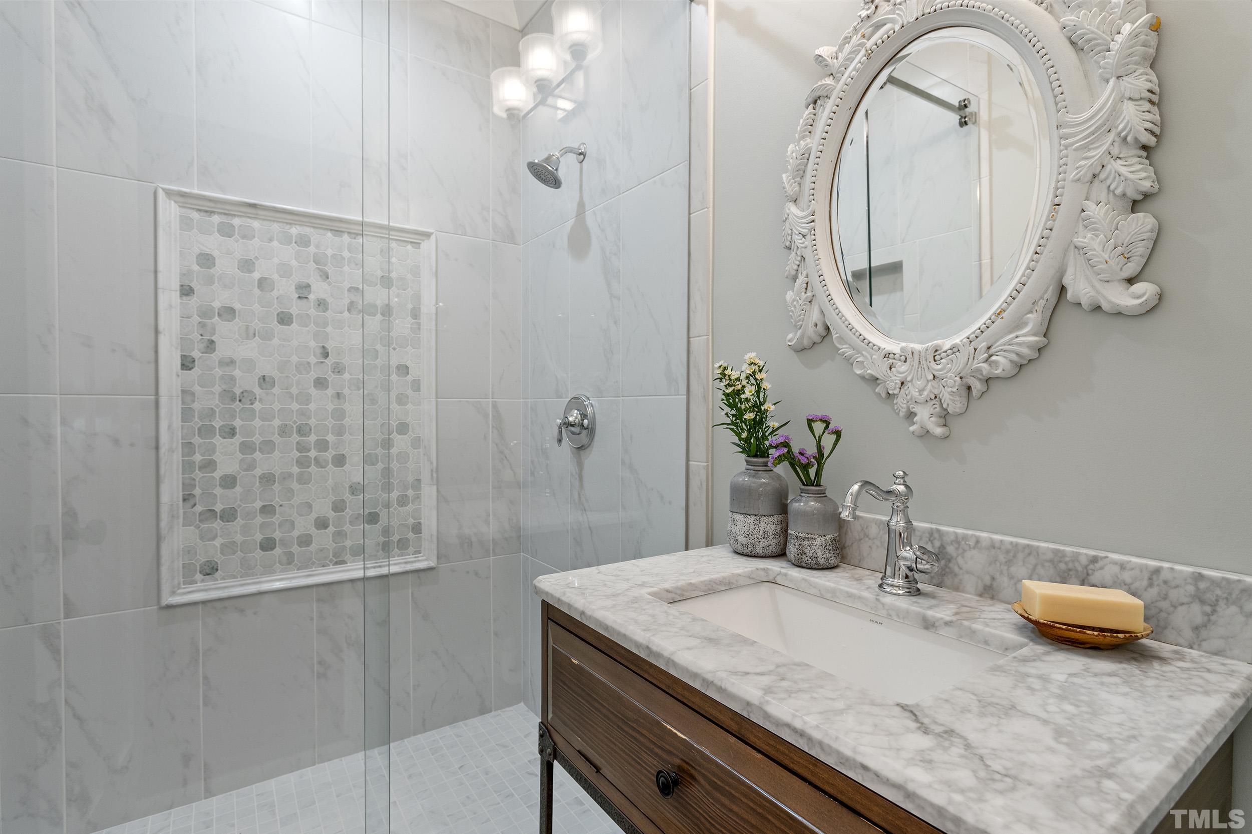 2511 Beechridge Road Raleigh, NC 27608 - Photo 29 of 45 a bathroom with a granite countertop sink a mirror and shower curtain
