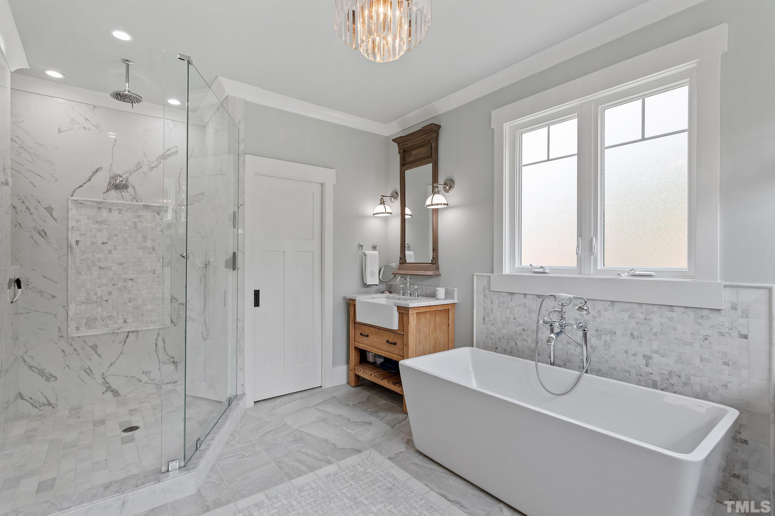 2511 Beechridge Road Raleigh, NC 27608 - Photo 34 of 45 a bathroom with a bathtub a shower a sink and a window