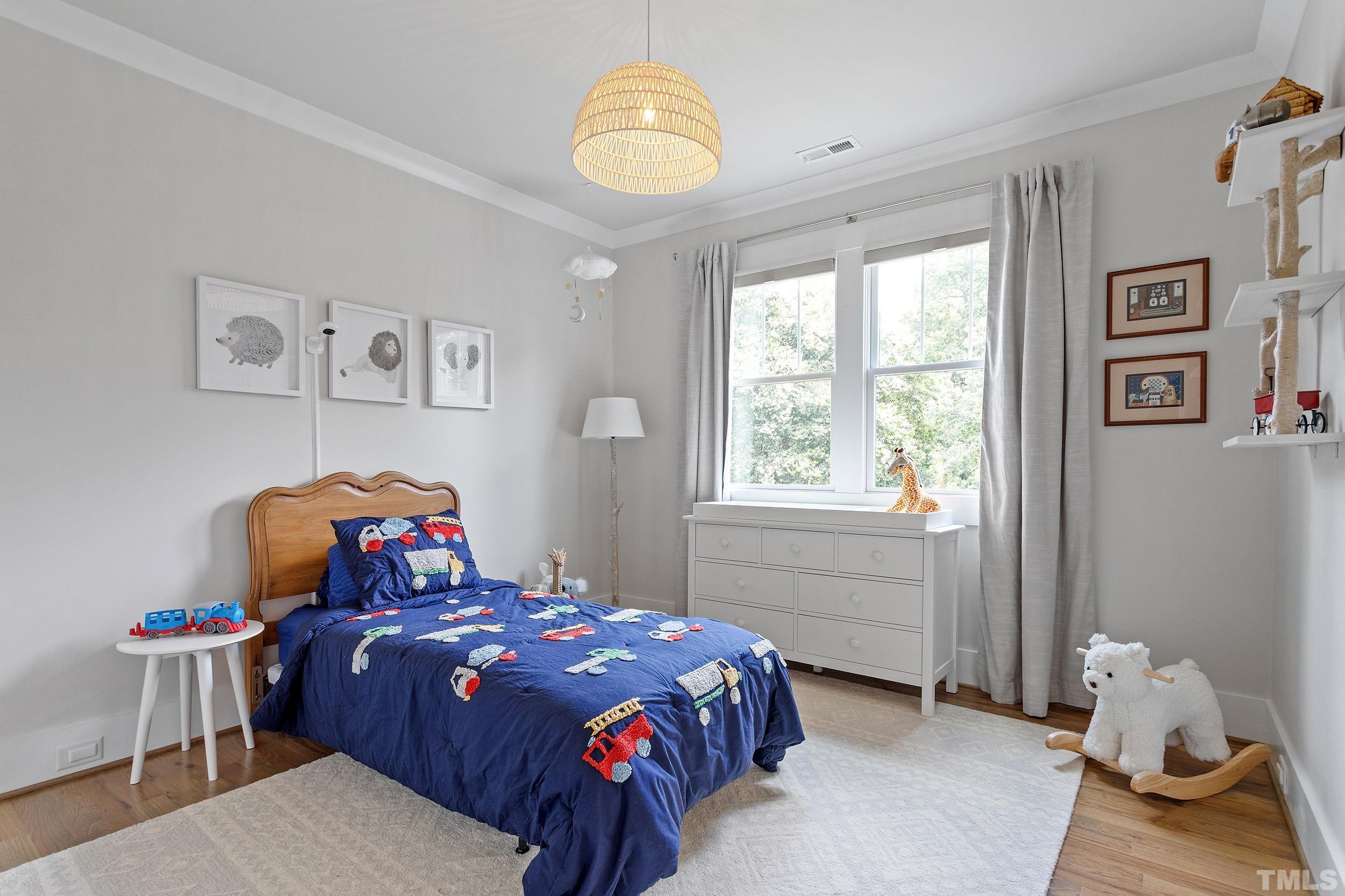 2511 Beechridge Road Raleigh, NC 27608 - Photo 37 of 45 a bedroom with a bed and a window