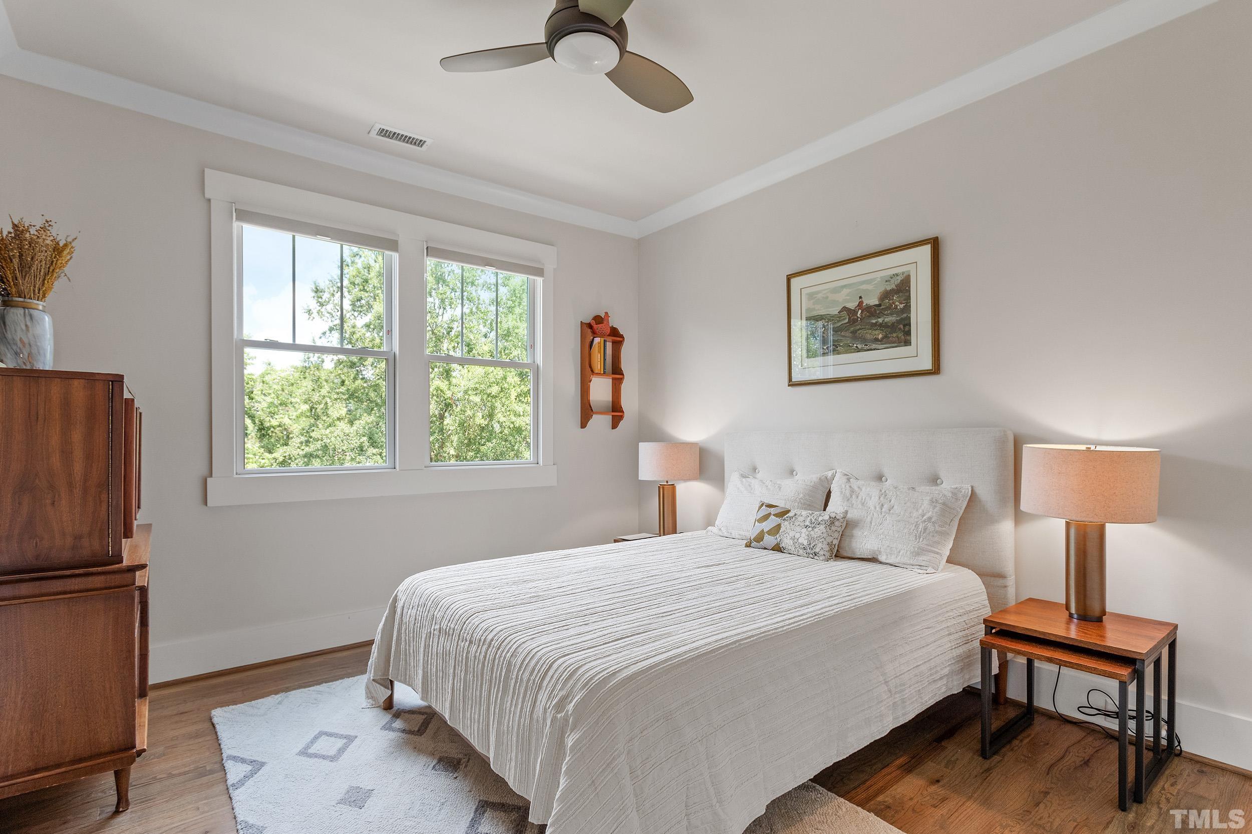 2511 Beechridge Road Raleigh, NC 27608 - Photo 39 of 45 a bedroom with a bed wall painting and a window