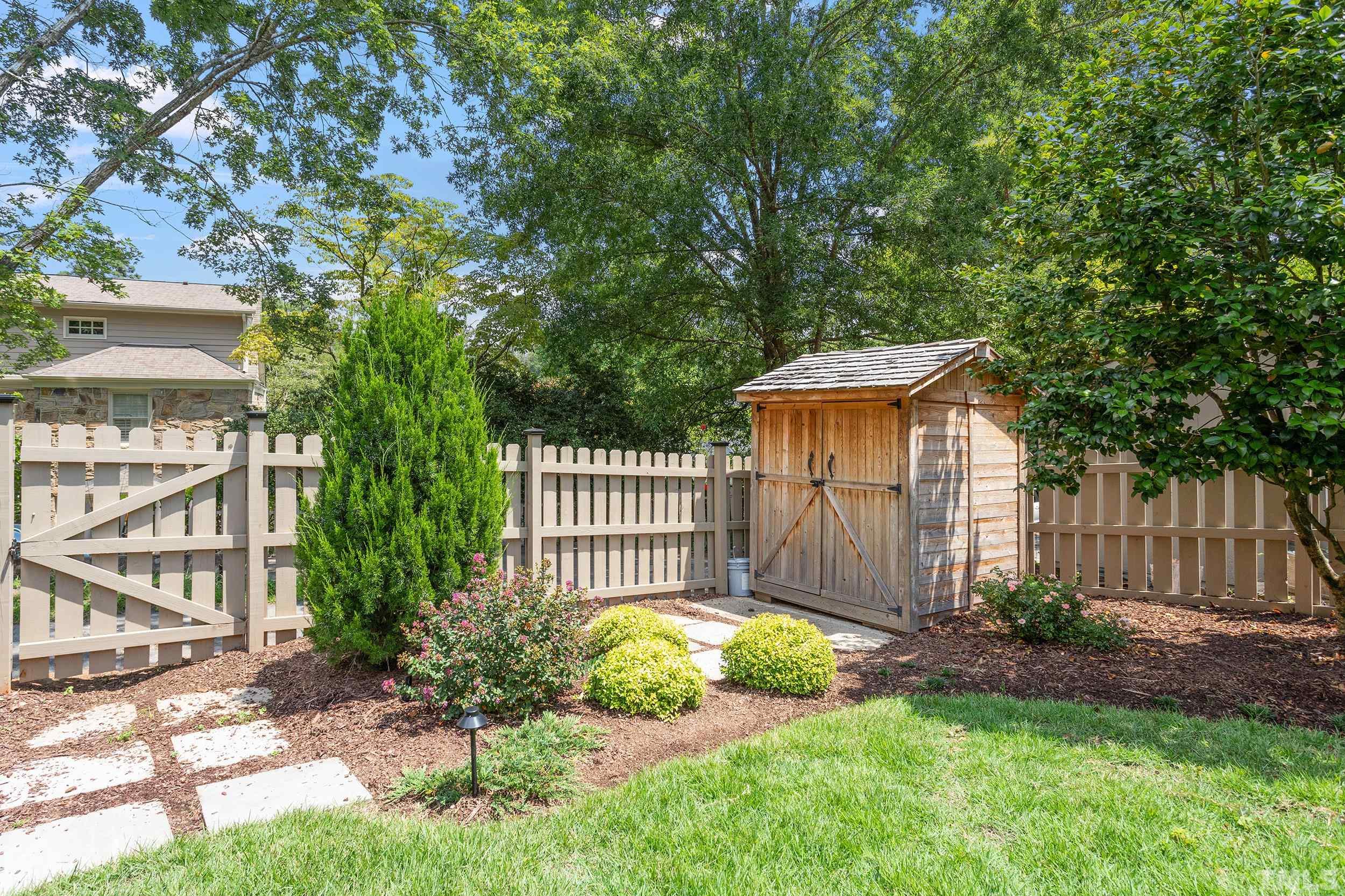 2511 Beechridge Road Raleigh, NC 27608 - Photo 44 of 45 a view of a house with a small yard and wooden fence